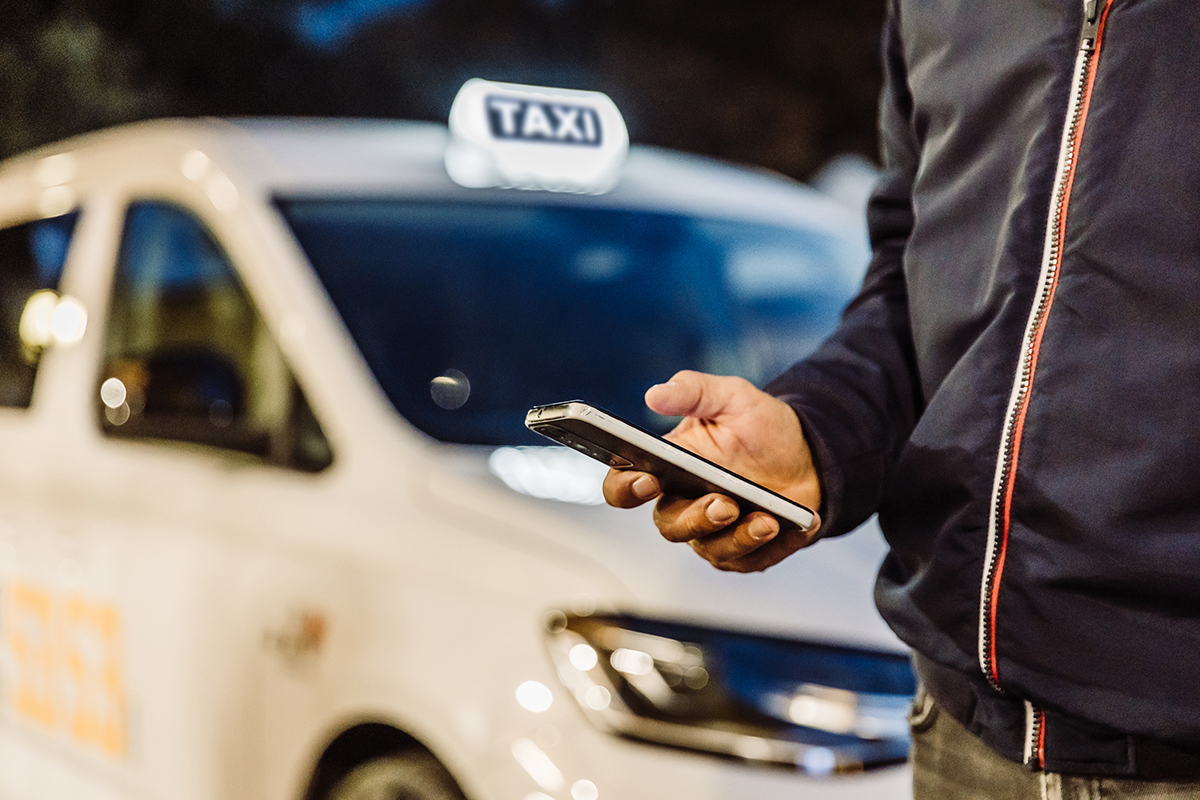 Smartphone used by Taxi Merano driver to share real-time taxi availability and location data for smarter mobility services.